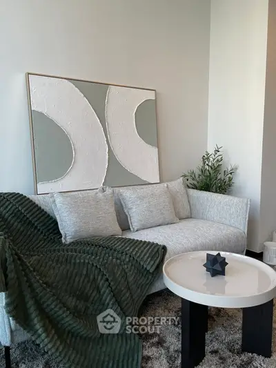 Stylish modern living room with elegant sofa and abstract art