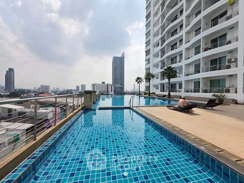 Stunning rooftop pool with city skyline view in modern high-rise building.