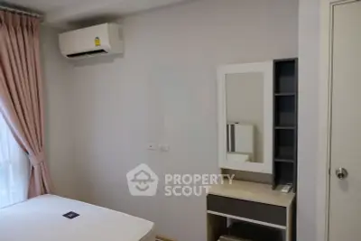 Modern bedroom with air conditioning and stylish vanity in a cozy apartment.