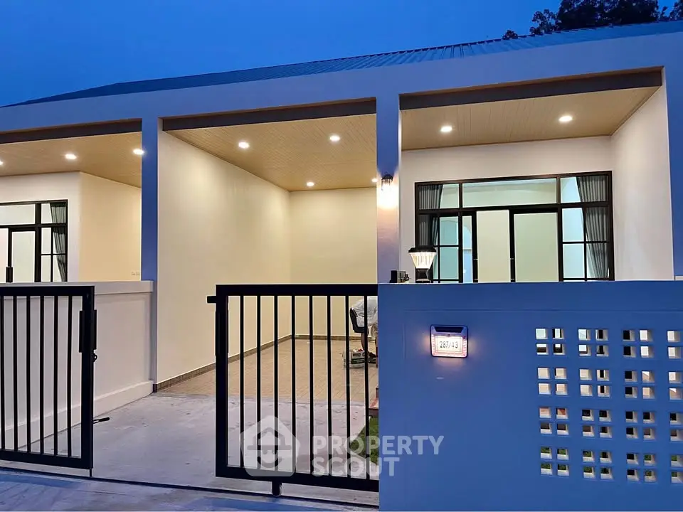 Modern single-story home with sleek exterior and spacious garage at dusk.