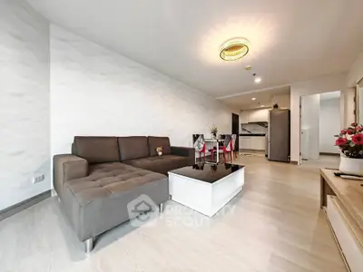 Modern living room with stylish furniture and open kitchen layout