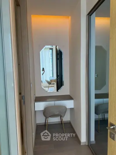 Modern vanity area with stylish chair and mirror in a contemporary apartment