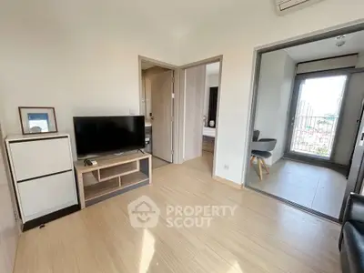 Modern living room with TV and balcony access in a stylish apartment