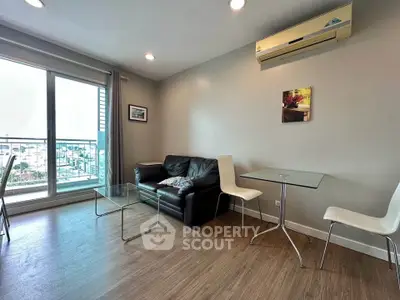 Modern living room with balcony view, featuring sleek furniture and air conditioning.