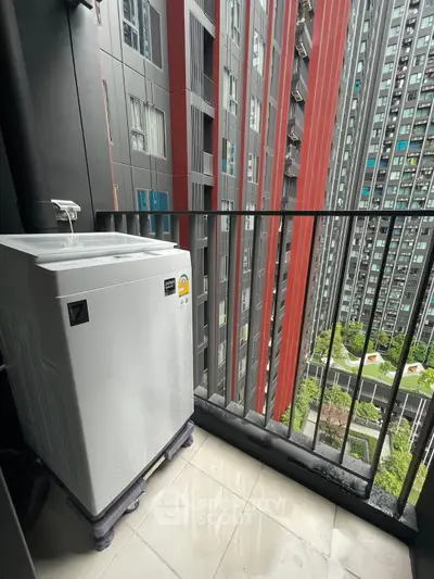 Modern high-rise balcony with washing machine and city view, perfect for urban living.