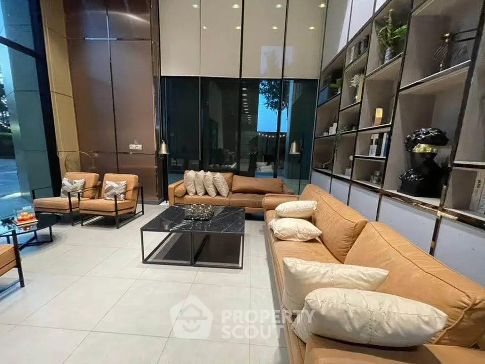 Luxurious modern living room with high ceilings and elegant leather sofas.