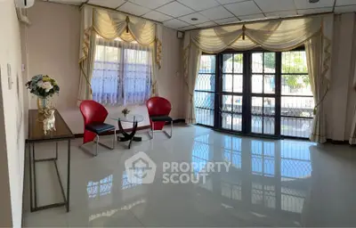 Spacious living room with modern decor and large windows for natural light.