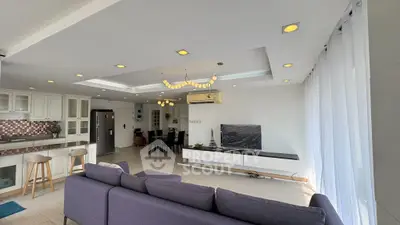 Spacious open-plan living room with modern kitchen and elegant decor