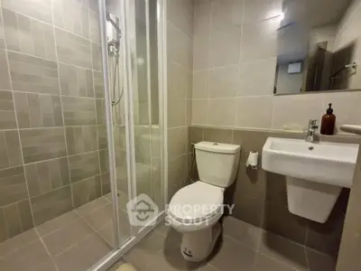 Modern bathroom with sleek shower and contemporary fixtures in a stylish apartment.