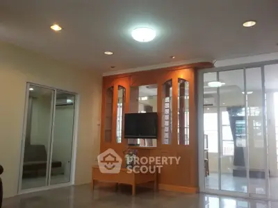 Spacious living room with modern decor and ample natural light