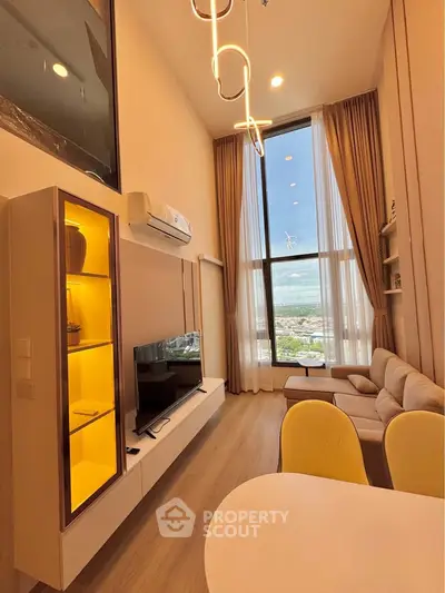 Luxurious high-ceiling living room with stunning floor-to-ceiling windows and modern decor.