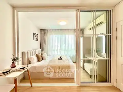 Bright and cozy bedroom with modern decor and sliding glass doors in a stylish apartment.