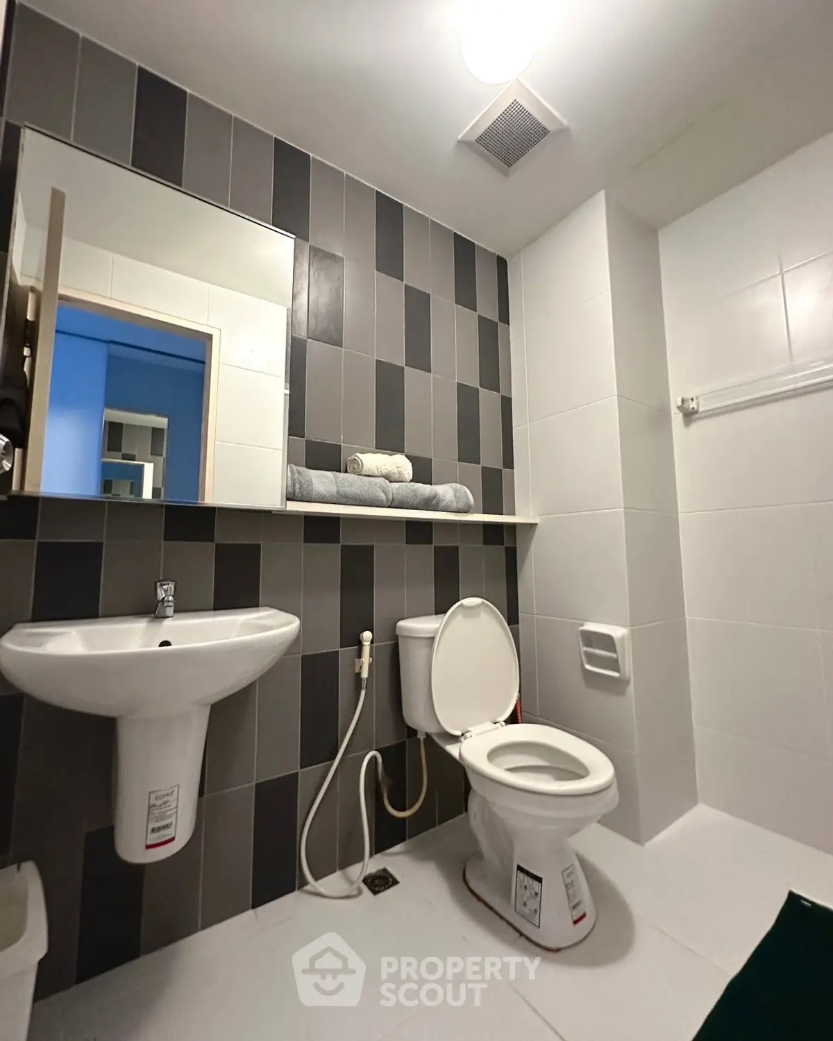 Modern bathroom with sleek fixtures and stylish tile design, perfect for contemporary living.