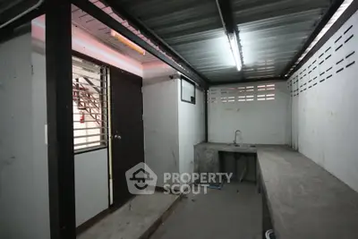 Industrial-style utility room with concrete countertops and metal ceiling