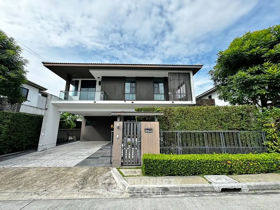 Modern two-story house with lush greenery and spacious driveway