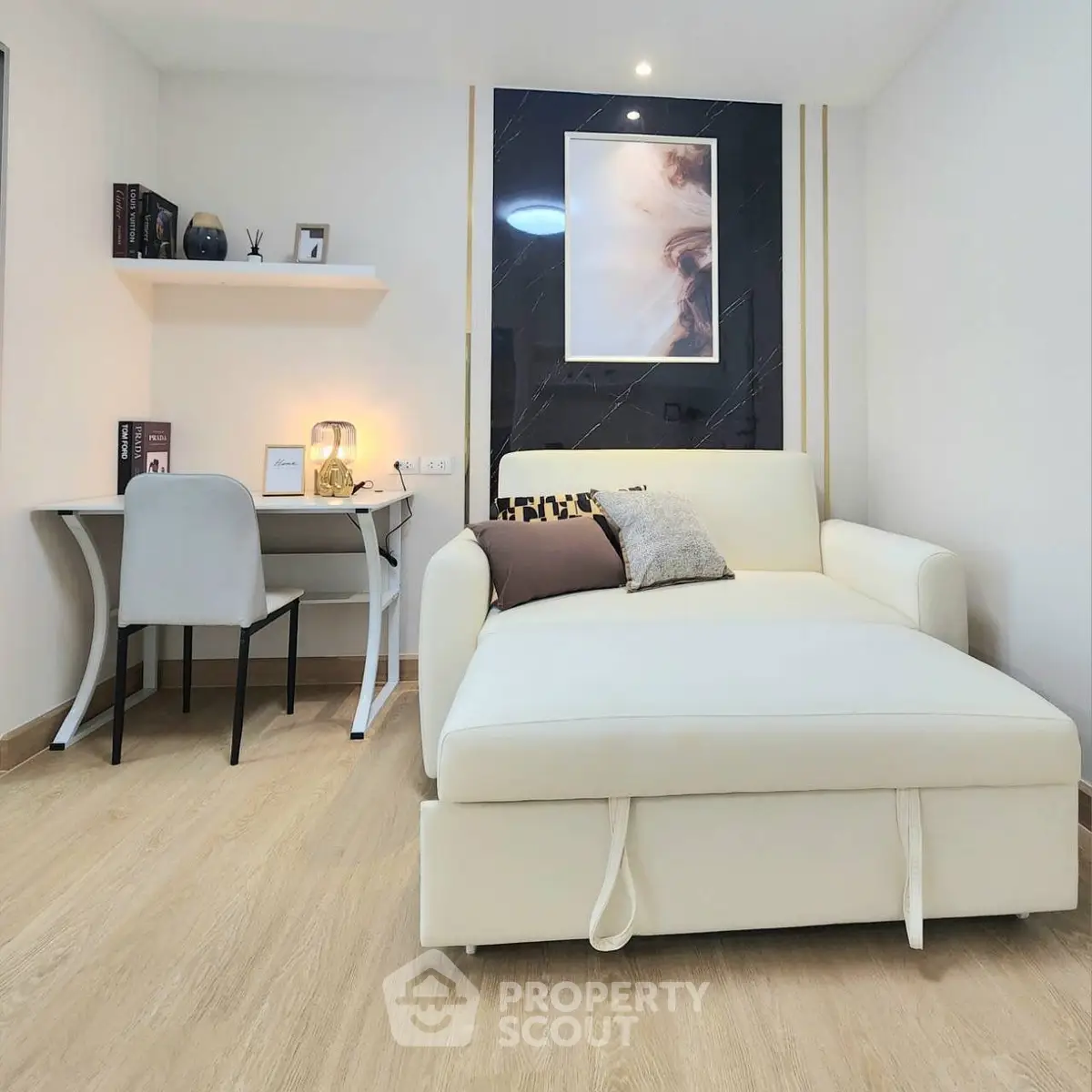 Modern living room with stylish furniture and cozy workspace, perfect for urban living.
