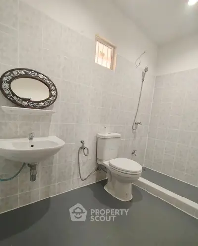 Spacious bathroom with modern fixtures and elegant tile design.