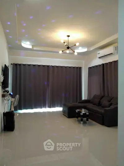 Spacious modern living room with stylish lighting and comfortable seating