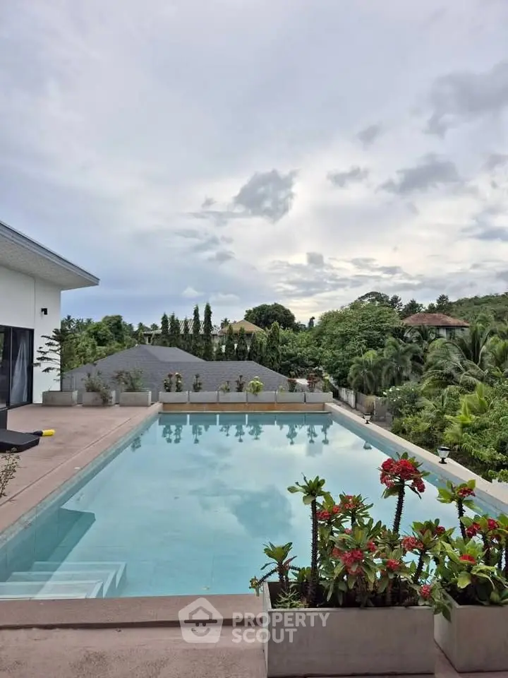 Luxurious outdoor pool with scenic view and lush greenery, perfect for relaxation and entertainment.
