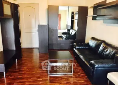Stylish living room with modern furniture and wooden flooring, perfect for urban living.
