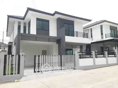 Modern two-story house with sleek design and gated entrance