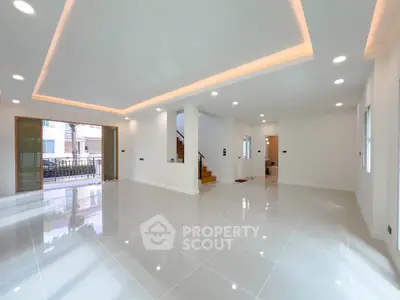 Spacious modern living room with glossy tile flooring and ambient lighting