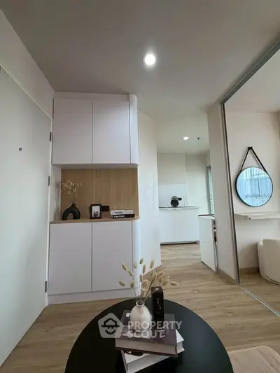 Modern apartment interior with stylish decor and open layout, featuring sleek cabinetry and elegant furnishings.