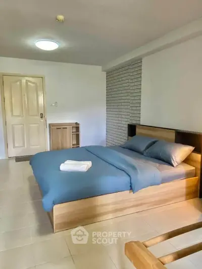 Spacious bedroom with modern wooden bed and minimalist decor