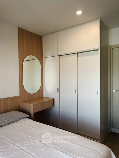 Modern bedroom with sleek wardrobe and stylish wooden accents