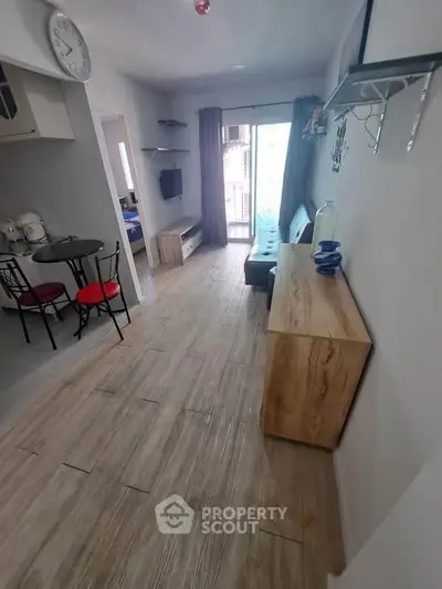 Modern living room with open layout and stylish decor, featuring a cozy seating area and dining space.