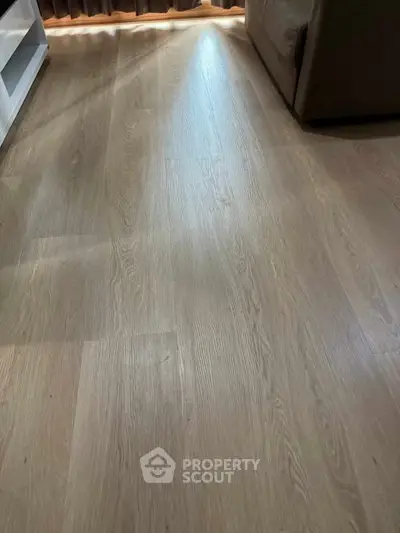 Elegant wooden flooring in a cozy living room setting with natural light.