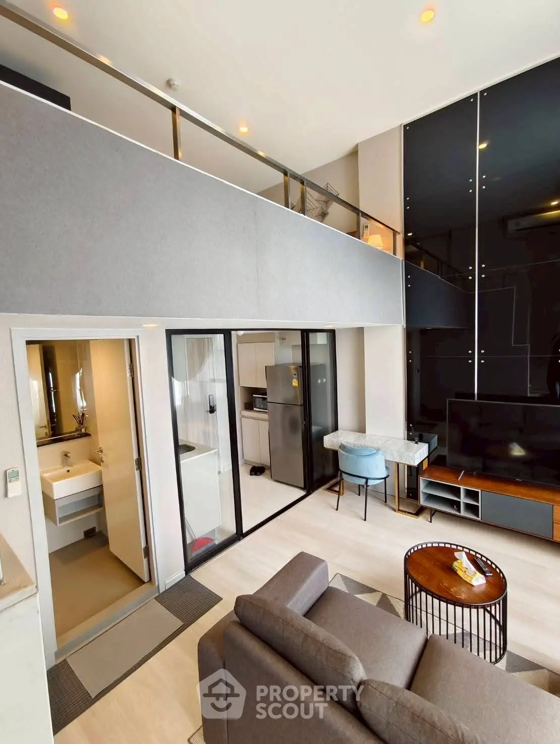 Modern loft apartment with sleek design and open layout, featuring a stylish living area and mezzanine.