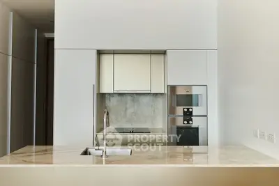 Sleek modern kitchen with marble countertop and built-in appliances