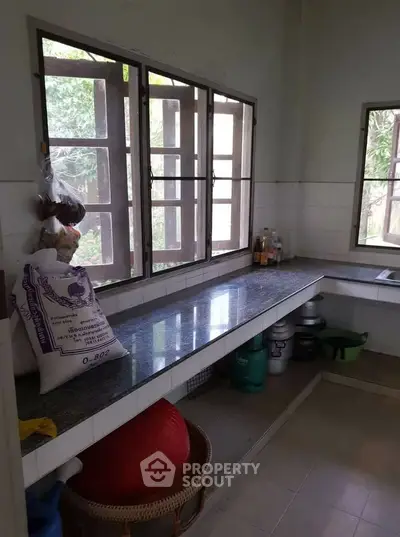 Spacious kitchen with large windows and ample counter space