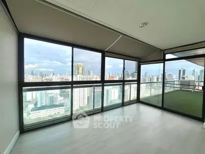 Spacious corner unit with stunning city views and large windows in modern high-rise apartment.