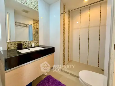 Modern bathroom with sleek vanity and spacious shower area