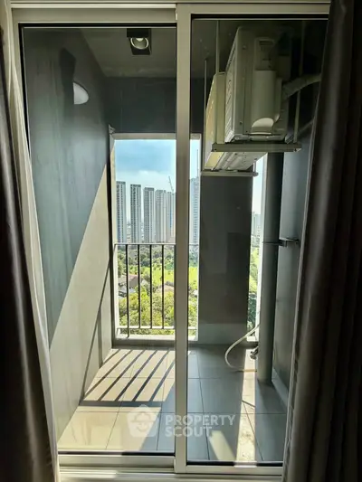 Modern balcony with city view and air conditioning unit, perfect for urban living.