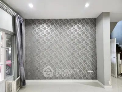 Modern interior with stylish wallpaper and natural light in a spacious room.