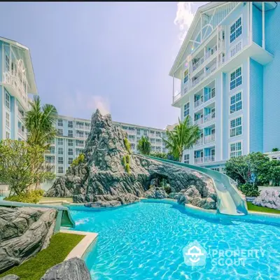 Luxurious residential complex with stunning pool and water slide, perfect for family living.