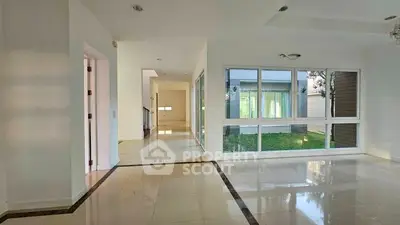 Spacious modern interior with large windows and garden view