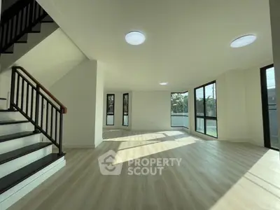 Spacious modern living room with large windows and natural light
