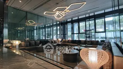 Luxurious modern living room with stylish lighting and floor-to-ceiling windows in upscale property.