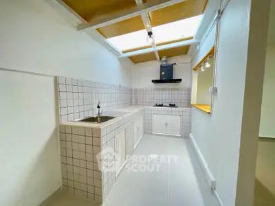 Bright kitchen with skylight and modern gas stove in minimalist design