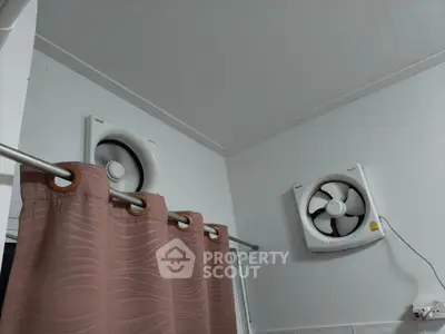 Bathroom with dual ventilation fans and shower curtain