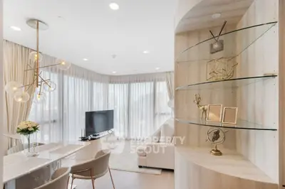 Luxurious modern living room with elegant decor and large windows offering natural light.