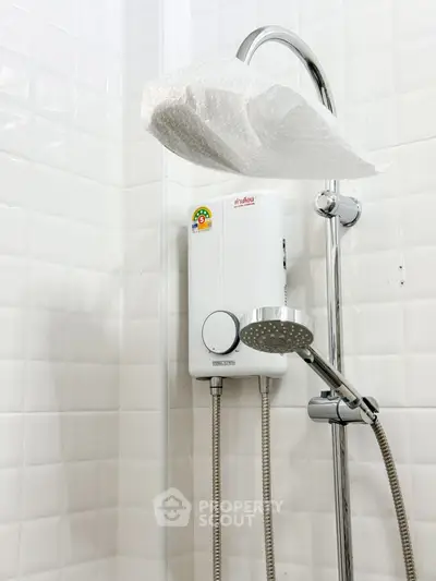 Modern bathroom with sleek shower and water heater installation.