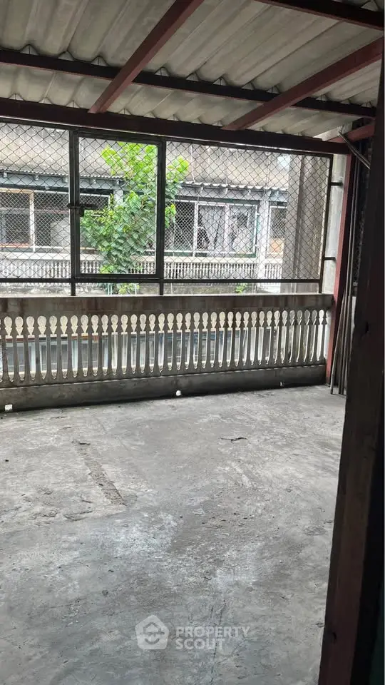 Spacious balcony with urban view and protective railing, ideal for city living.