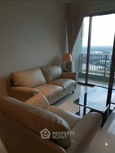 Modern living room with elegant furniture and stunning city view from balcony.