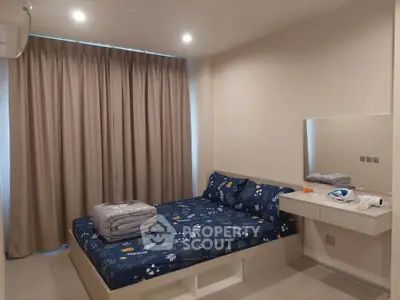 Cozy bedroom with modern decor and ample natural light