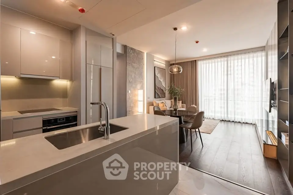 Modern open-plan kitchen and living area with sleek design and natural light.